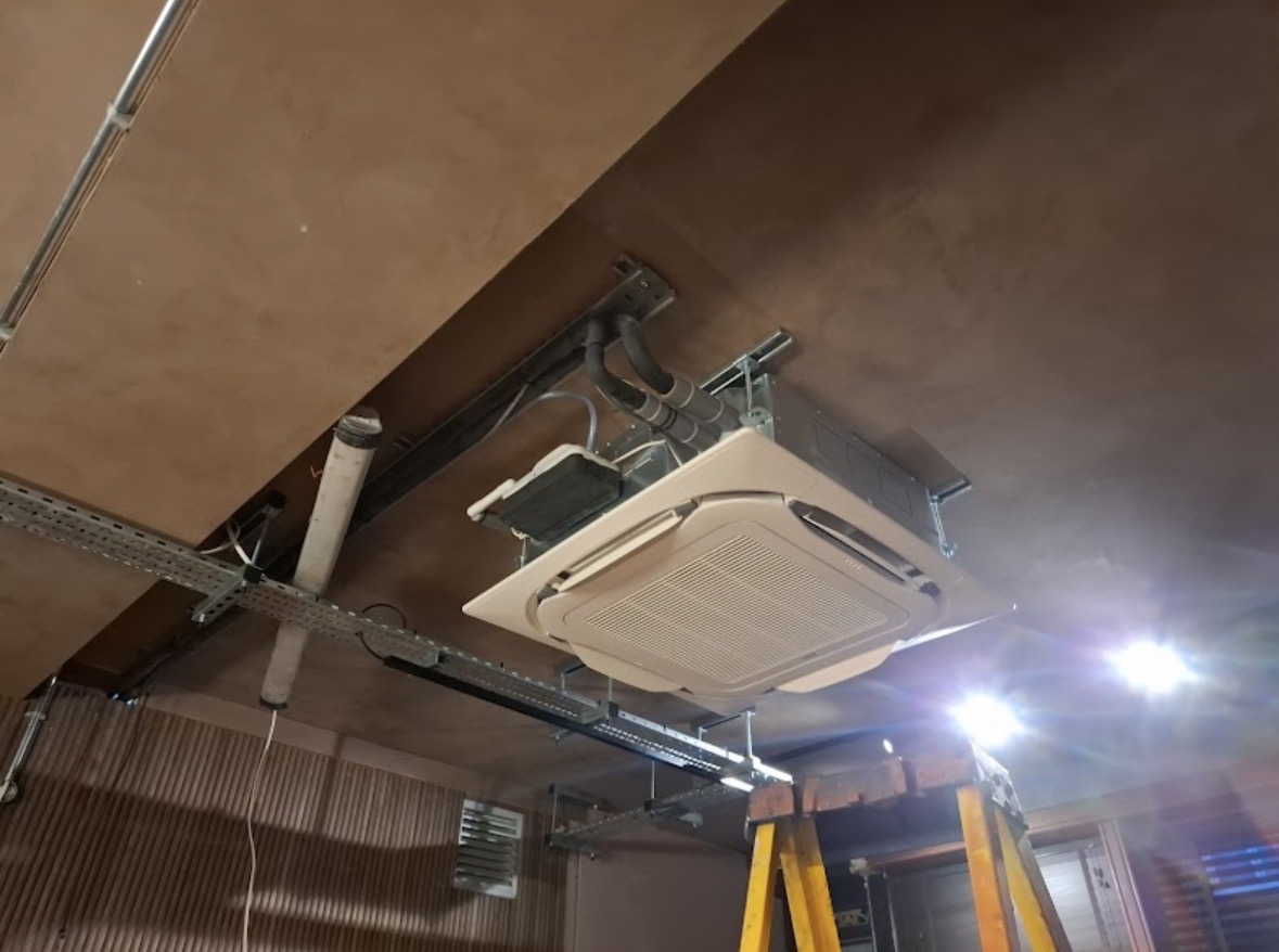 Cassette unit being installed in commercial ceiling